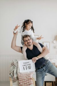 Father and Daughter Smiling at the Camera ‣ Raver Rawlings Law Group PLLC Father and Daughter Smiling at the Camera